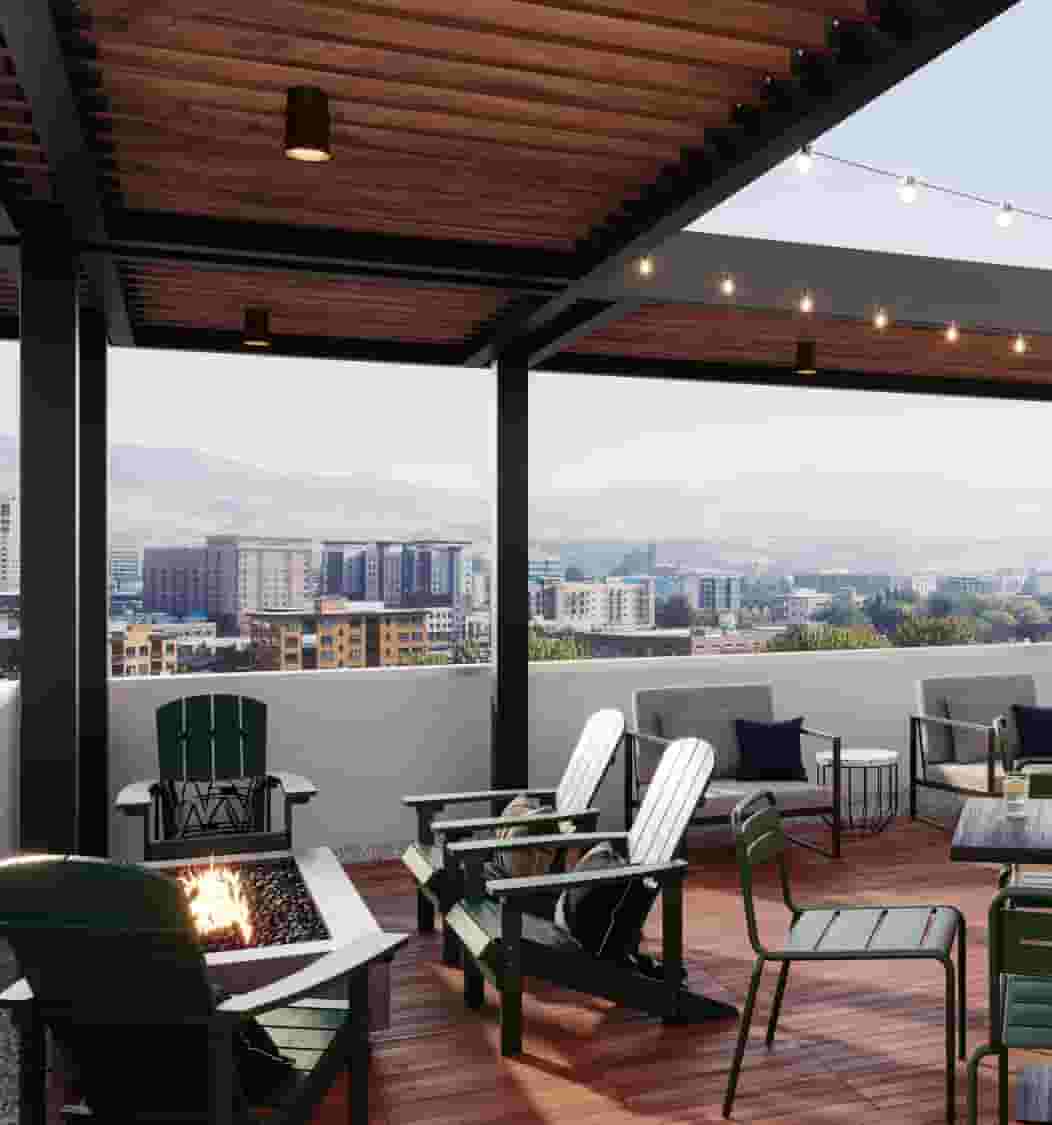 Skydeck lounge with firepit, seating, TV, and bar overlooking Boise and BSU campus